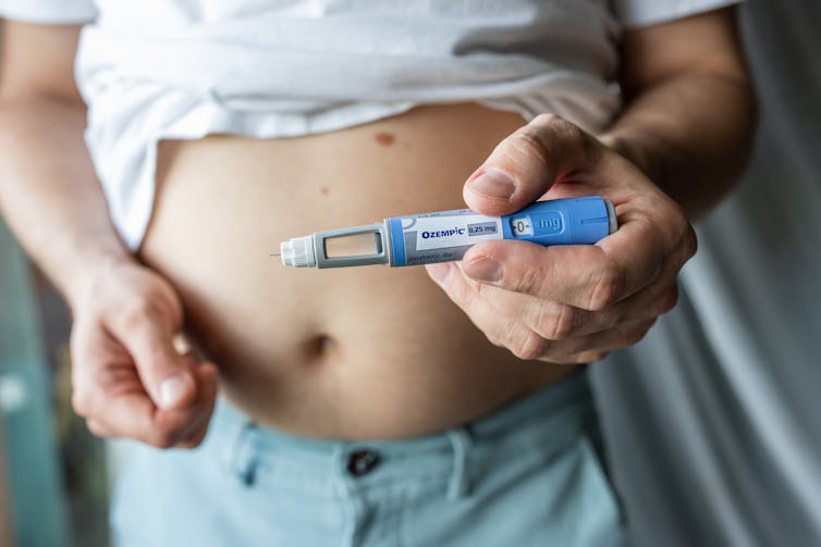 Man holds Ozempic injection