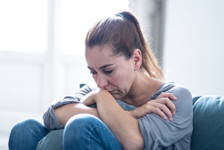 Depressed woman looks down