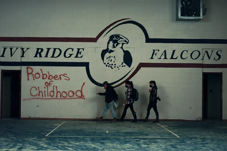 Three people at Ivy Ridge Falcons school