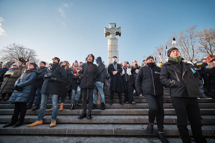 Protesters stand on steps in Tallinn, Estonia.