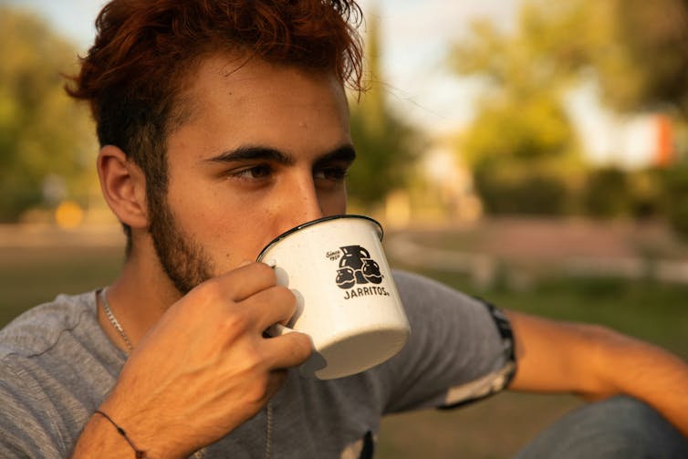 Man drinks soda from a cup