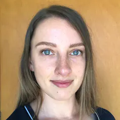 a white woman with blue eyes and long, straight hair