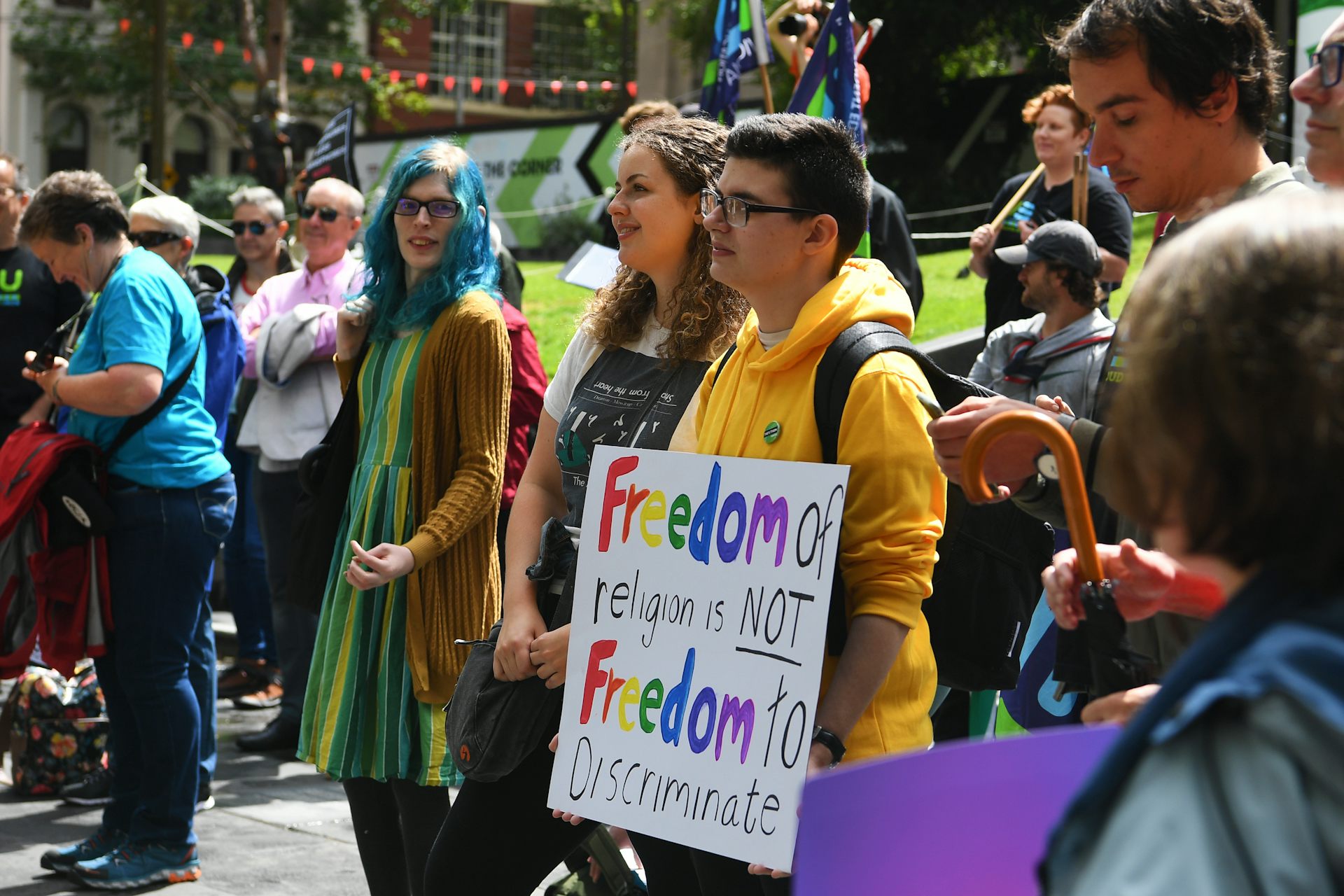 People at a protest, carrying signs.