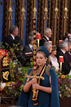 Penny Mordaunt at the coronation, walking with a very large sword.