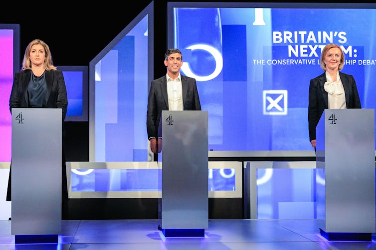 Penny Mordaunt, Rishi Sunak and Liz Truss stand at podiums in a TV studio.