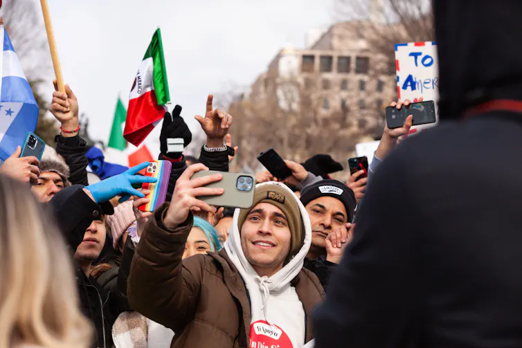 Carlos Eduardo Espina takes selfies with fans.
