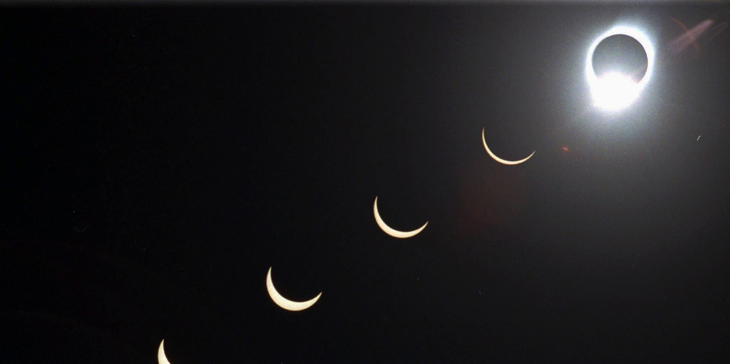 A solar eclipse, with the Moon covering the Sun with just an outline of light visible around it, in the top right, with varying stages of coverage moving from the bottom left to the right, as the sliver of Sun visible gets smaller. 