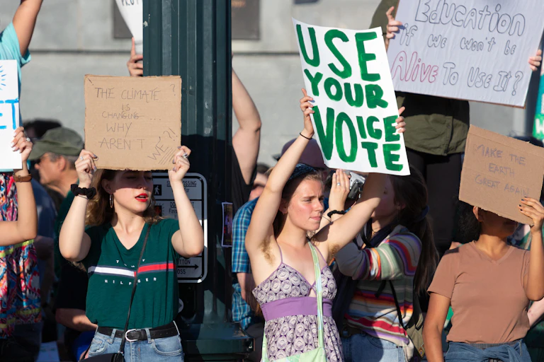 A young woman win a banner saying: use your vote.