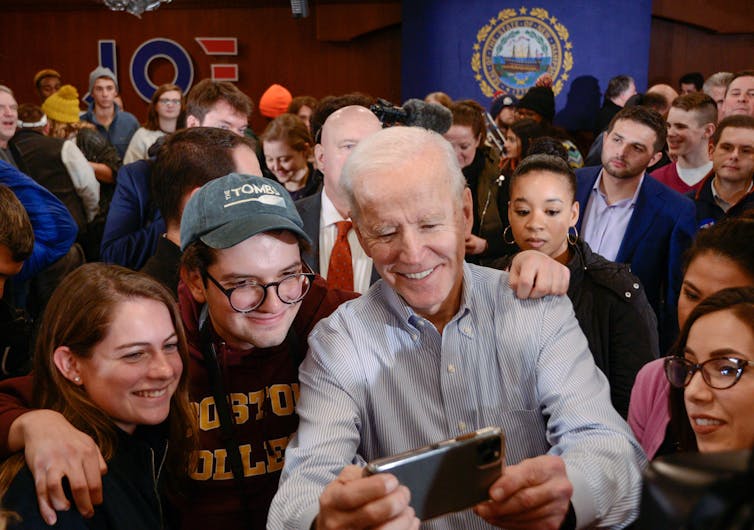 Joe Biden during the 2020 campaign surrounded by young people.