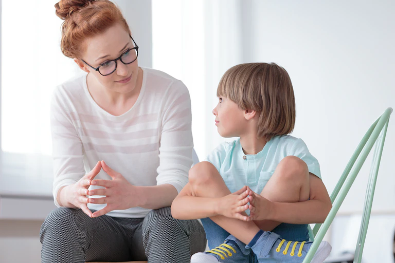 Woman talking to young boy