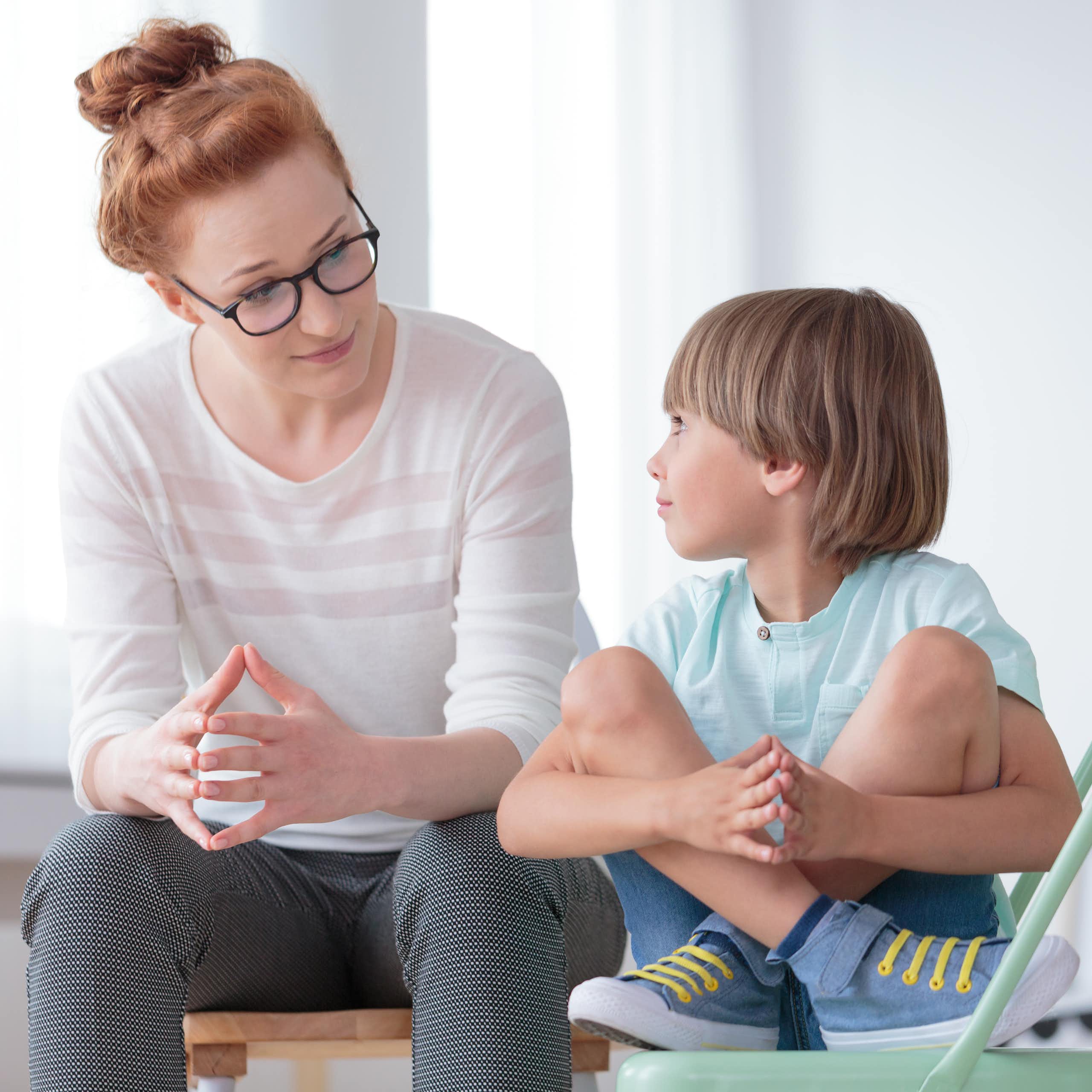 Woman talking to young boy