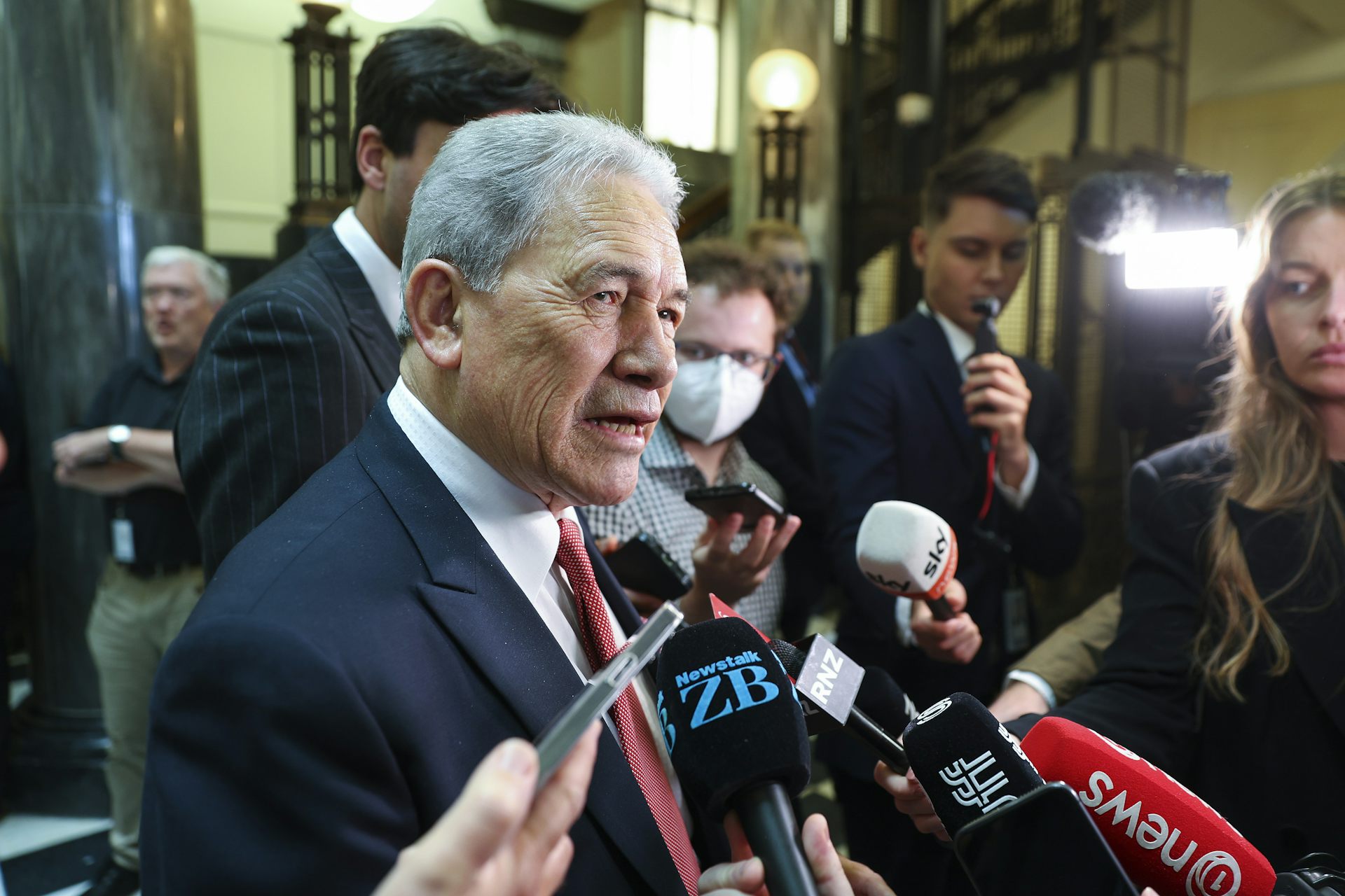 Winston Peters speaking to media inside parliament lobby