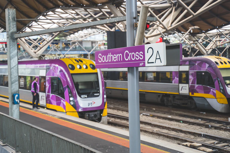 Two V/Line trains at platforms under the roof of Southern Cross Station