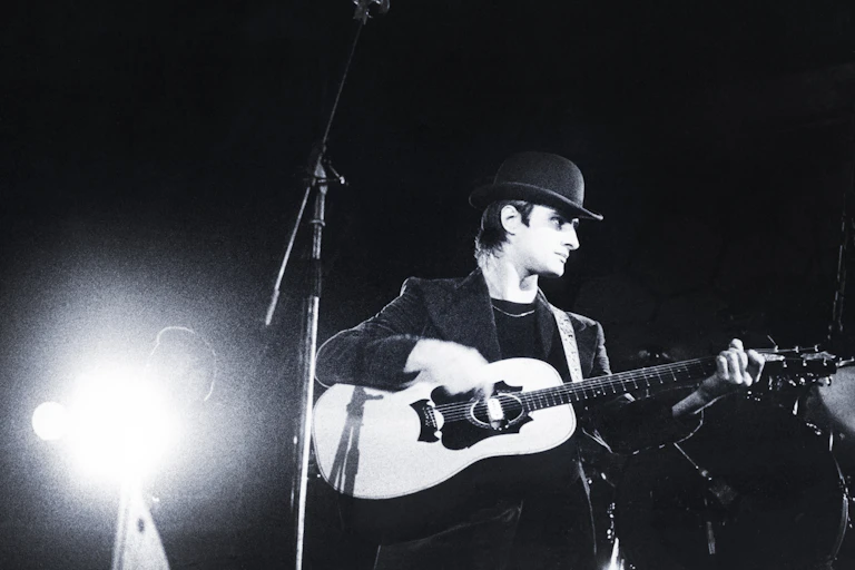 Steve Harley on stage with guitar