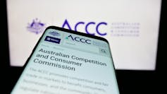 A mobile phone open to the homepage of the ACCC website