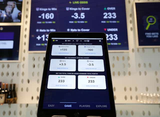 An electronic tablet displays betting odds.