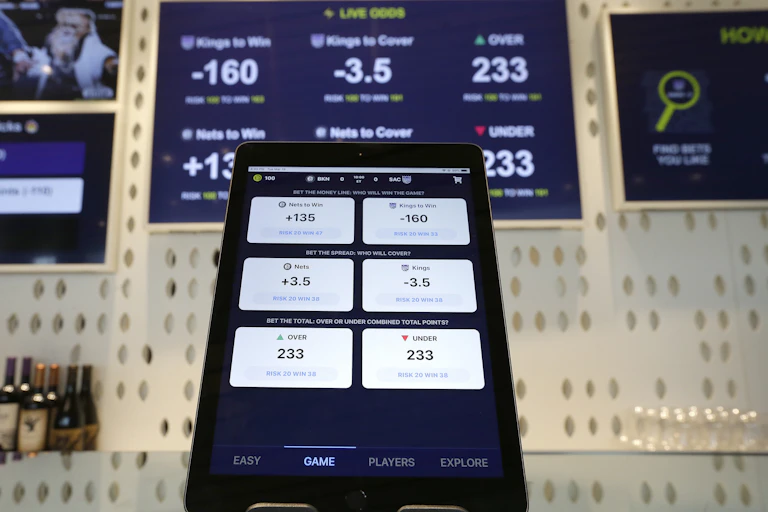 An electronic tablet displays betting odds.