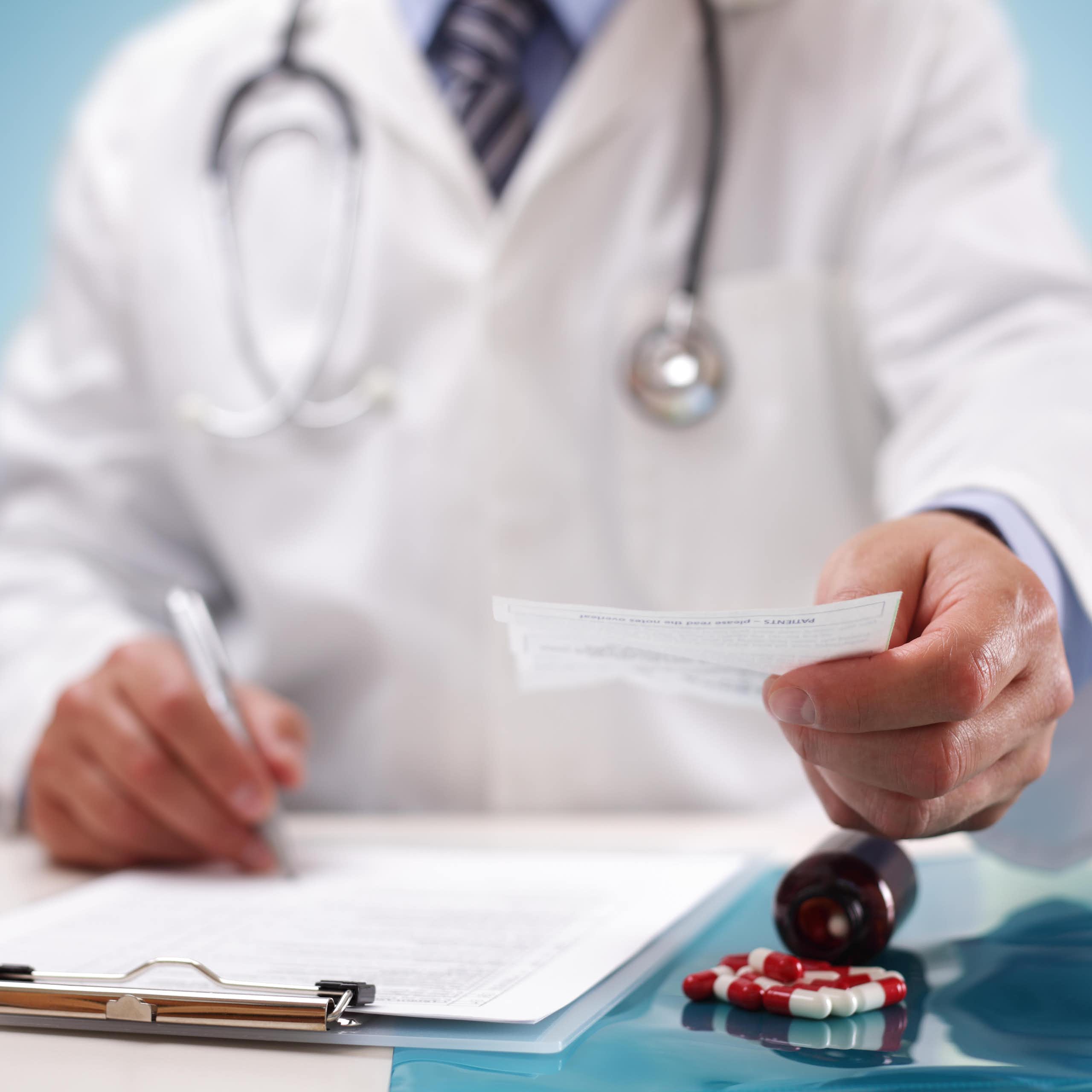 A doctor handing over a prescription