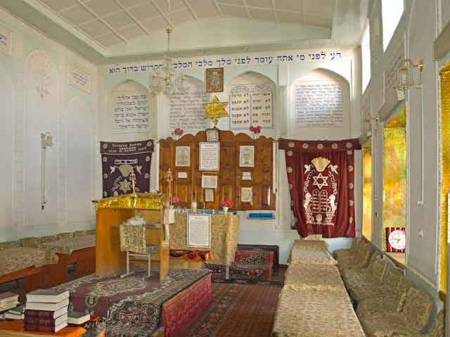 A carpeted interior of a synagogue.