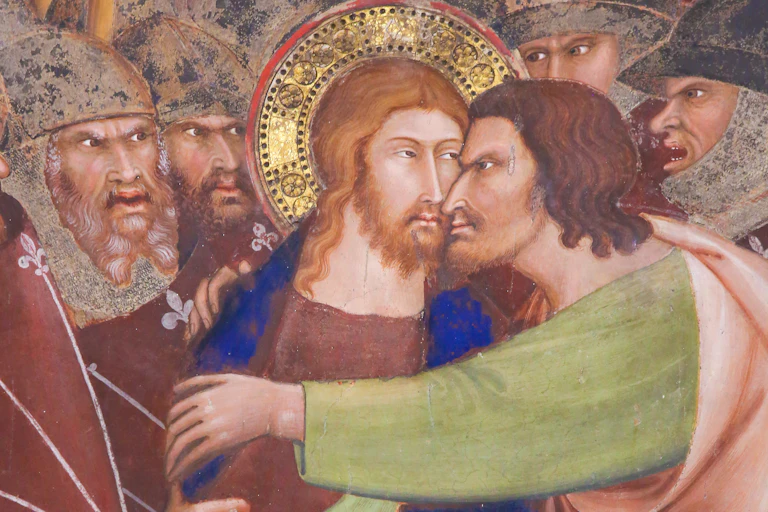 Detail from a fresco showing Judas betraying Jesus.