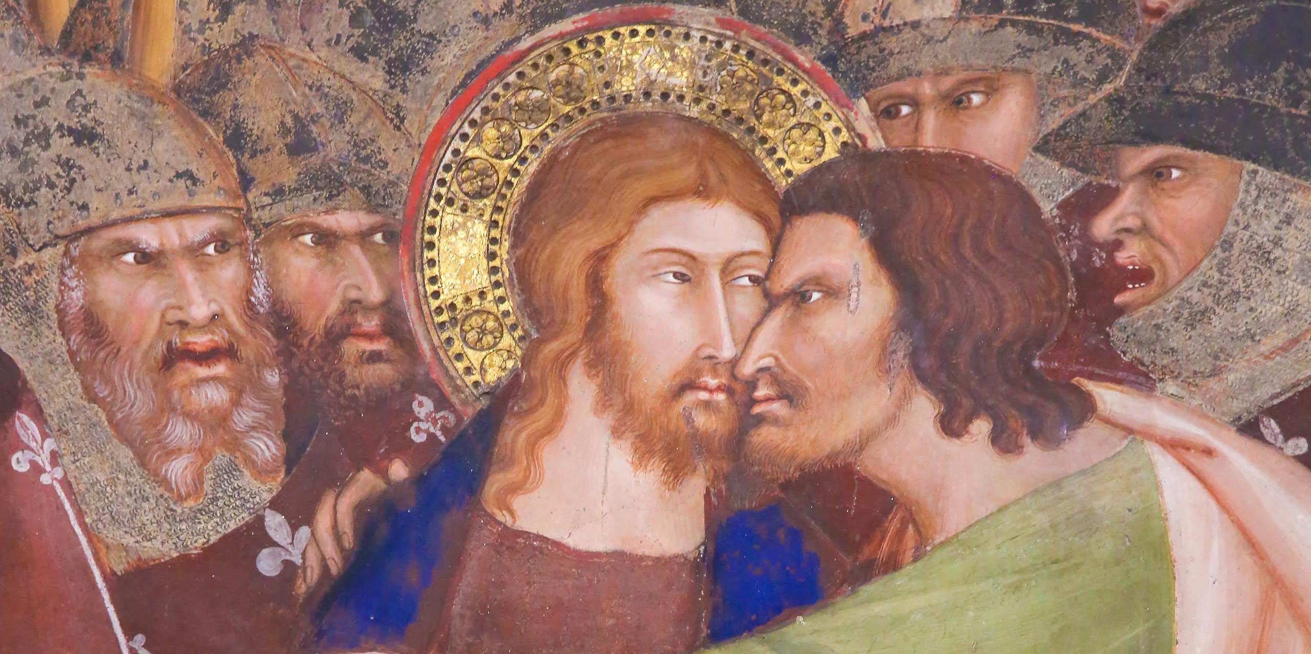 Detail from a fresco showing Judas betraying Jesus.