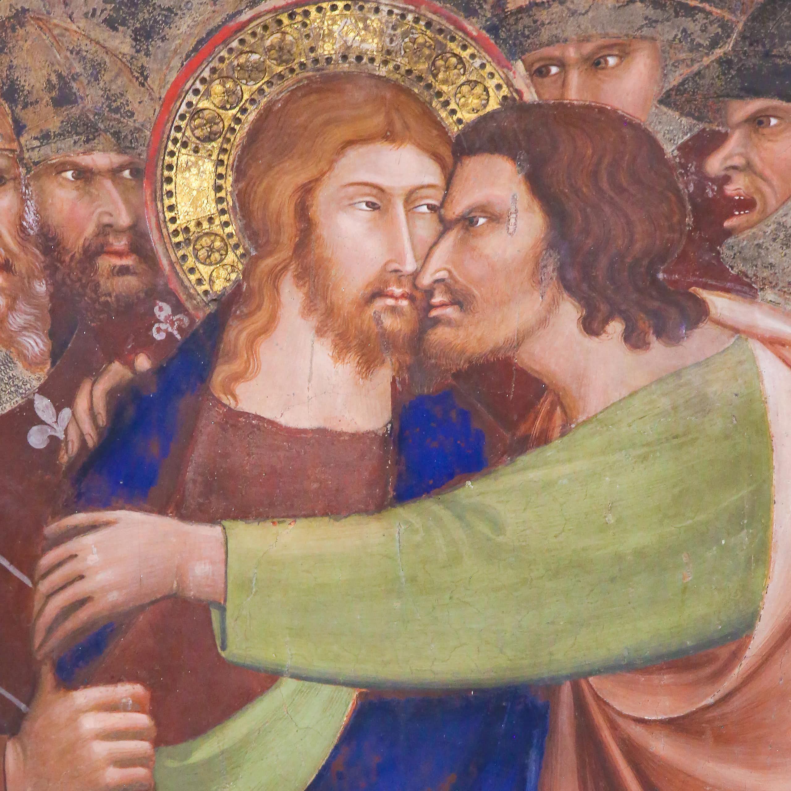 Detail from a fresco showing Judas betraying Jesus.