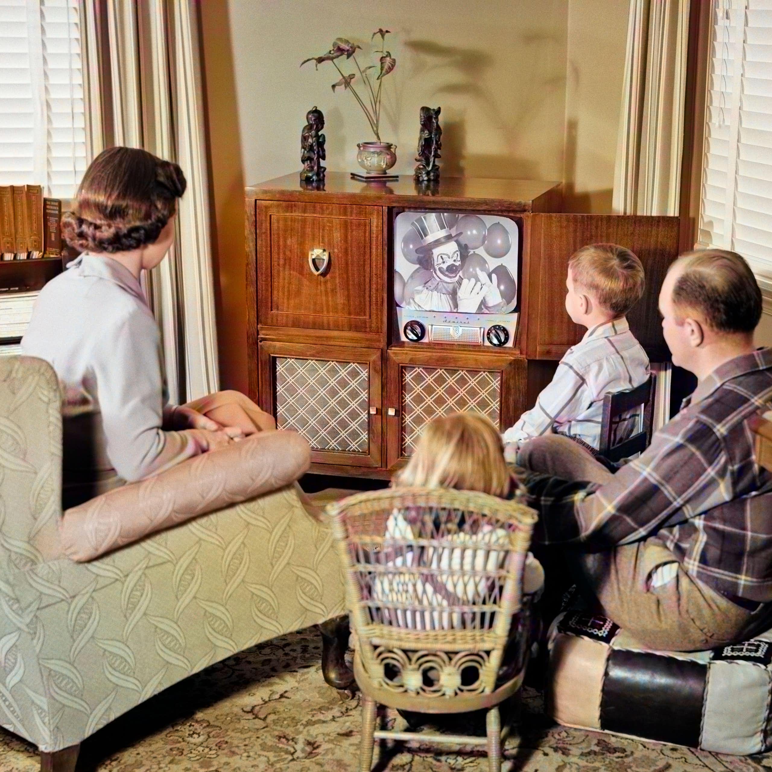A family gathered around a television set.