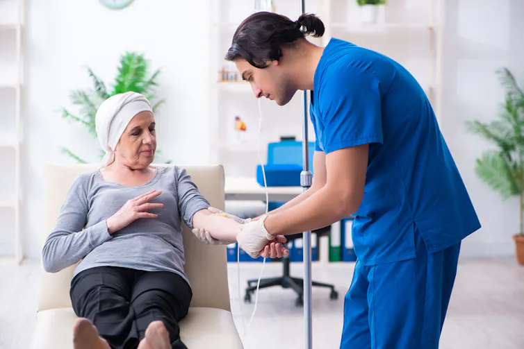 Doctor holds patient's arm with IV