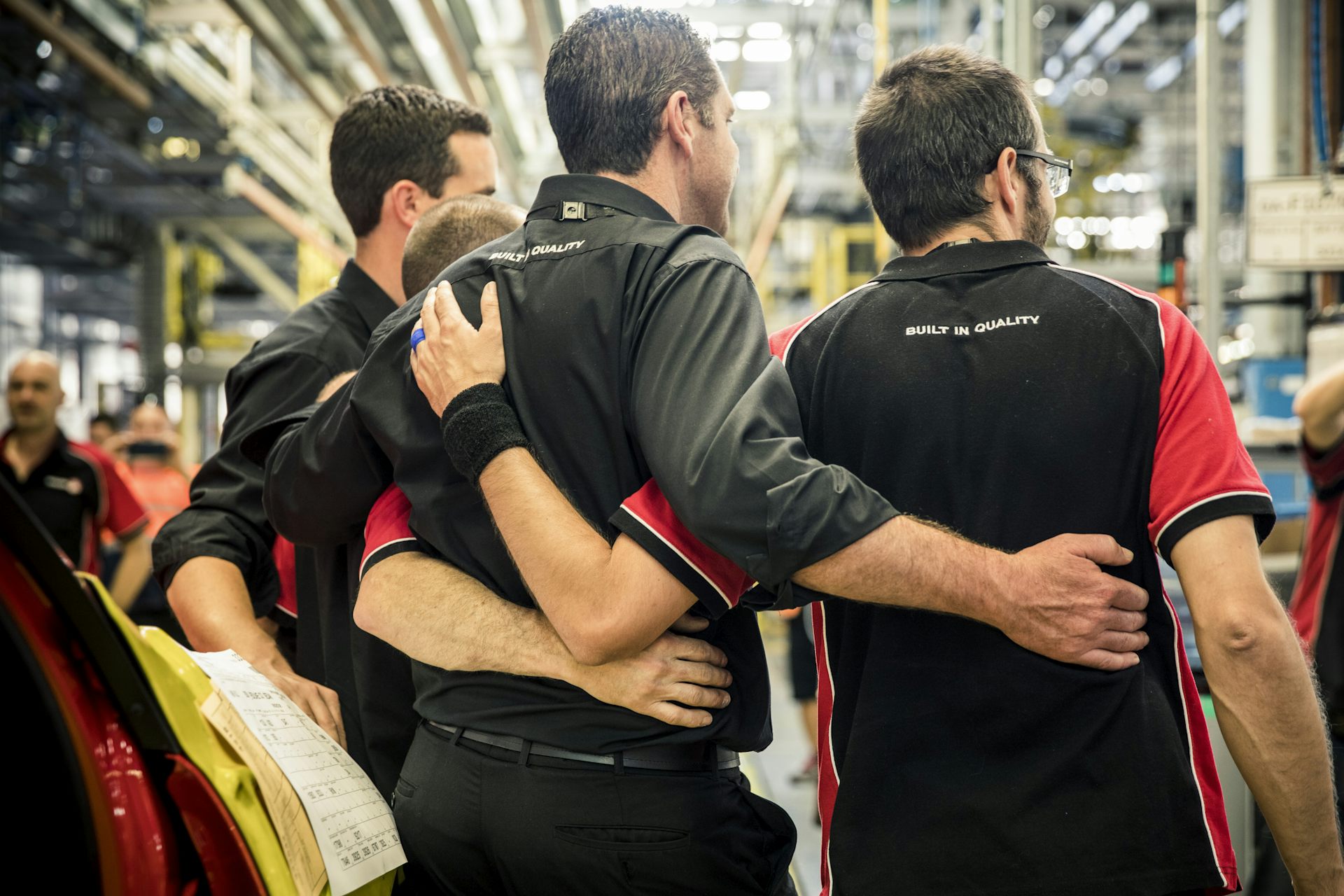 workers embrace in factory