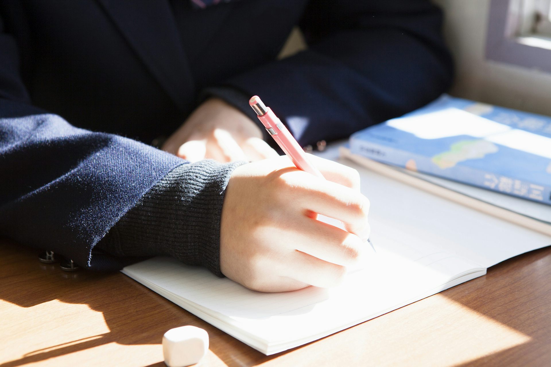 A student writes in a notebook.