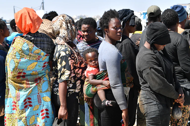 African migrants attempting to flee to Europe disembark in Sfax from a vessel belonging to the Tunisian coastguard, after having been intercepted at sea, on 10 August 2023.