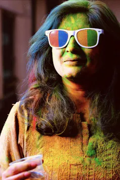 A woman in sunglasses and colours.