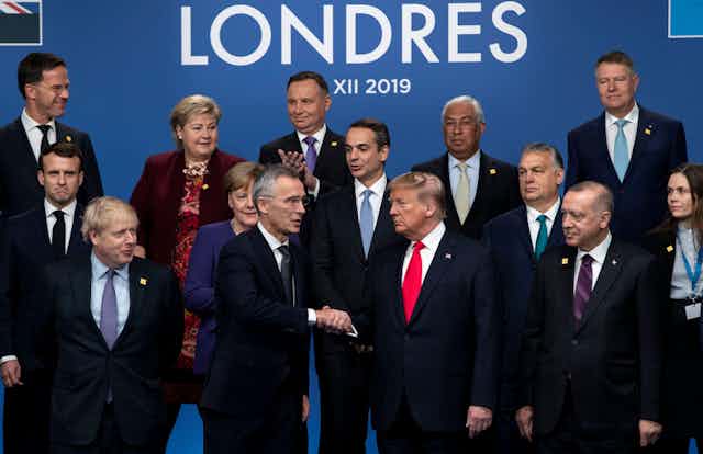 Donald Trump in middle of picture, at Nato meeting in 2019, surrounded by Nato leaders.