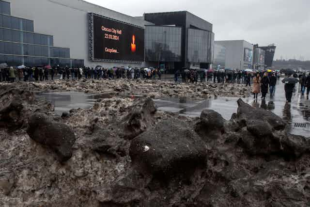 A large queue of mourners near the Crocus City Hall where a terrorist attack took place.