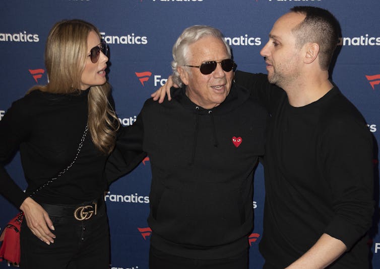 A young woman wearing sunglasses, an older man wearing sunglasses, and a middle-aged man.