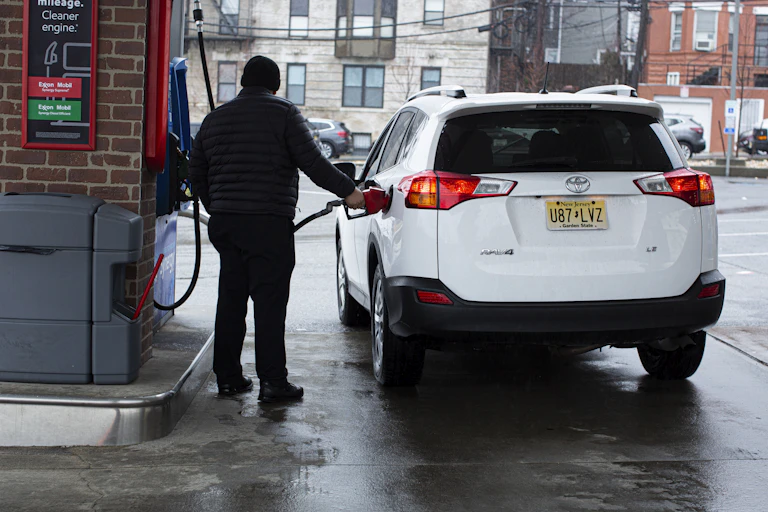 A gas station attendant refuels a car at a gas station in Weehawken, New Jersey, in March 2022.