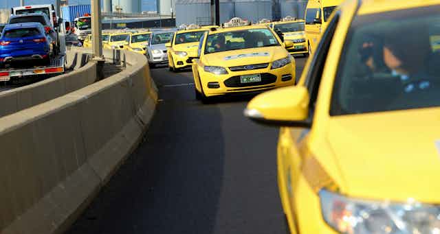 Taxis crawl across Melbourne's Bolte Bridge in protest at changes to the taxi industry after the introduction of ride-sharing.