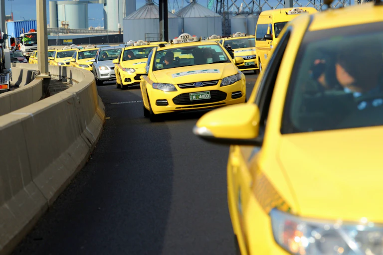 Taxis crawl across Melbourne's Bolte Bridge in protest at changes to the taxi industry after the introduction of ride-sharing.
