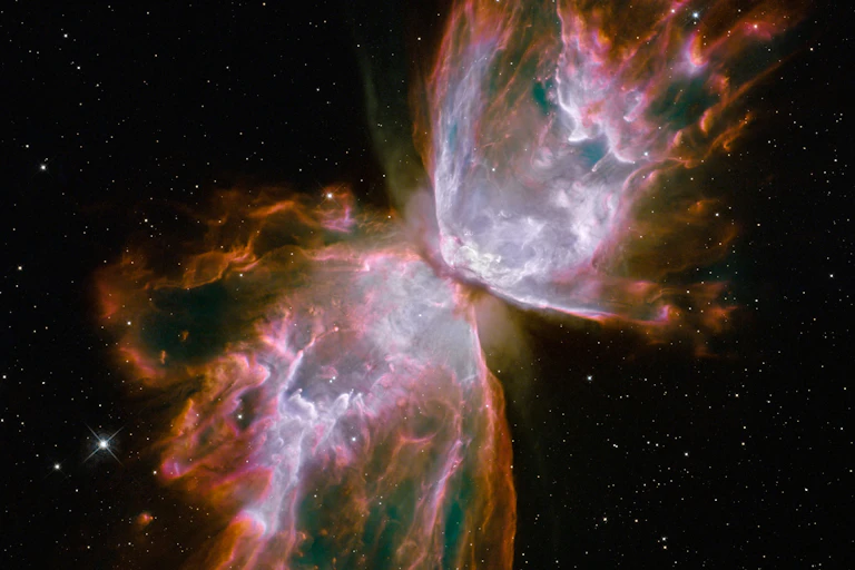 Large, brightly colored clouds of gas against a dark, starry sky.