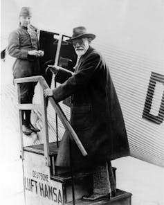 Sigmund Freud boarding an airplane.