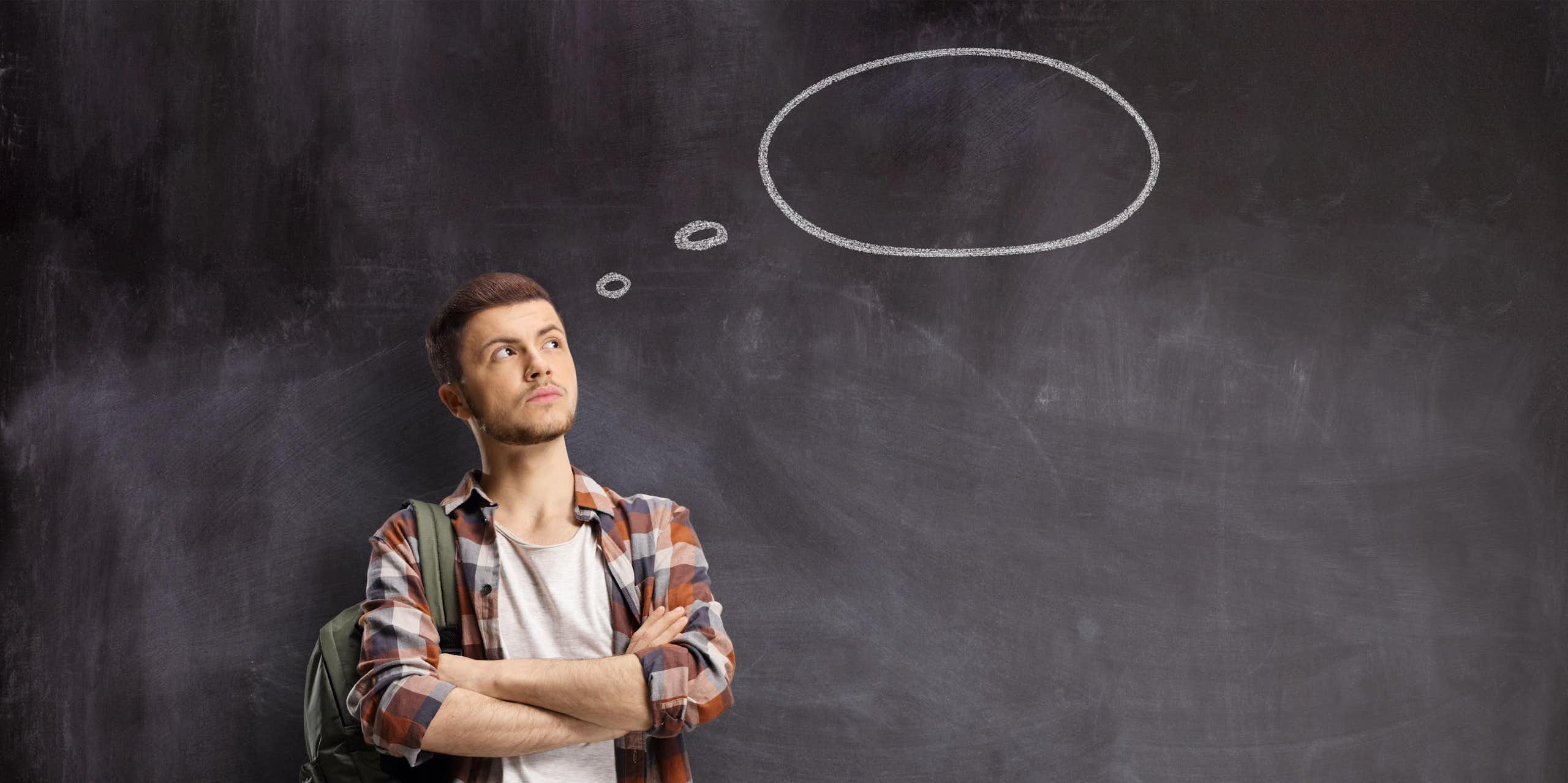 Young man with a blank thought bubble behind him on a chalkboard