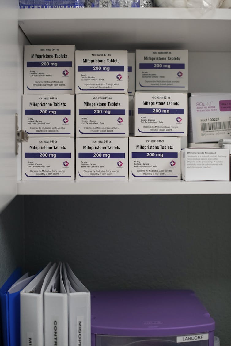 White boxes of Mifepristone are seen stacked in a shelf.