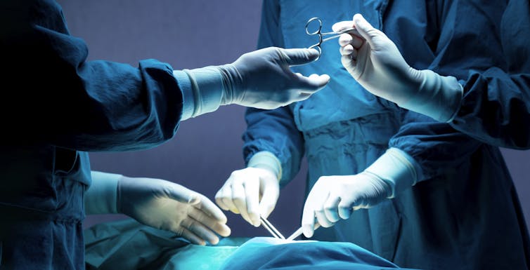 Team of surgeons operating on a patient