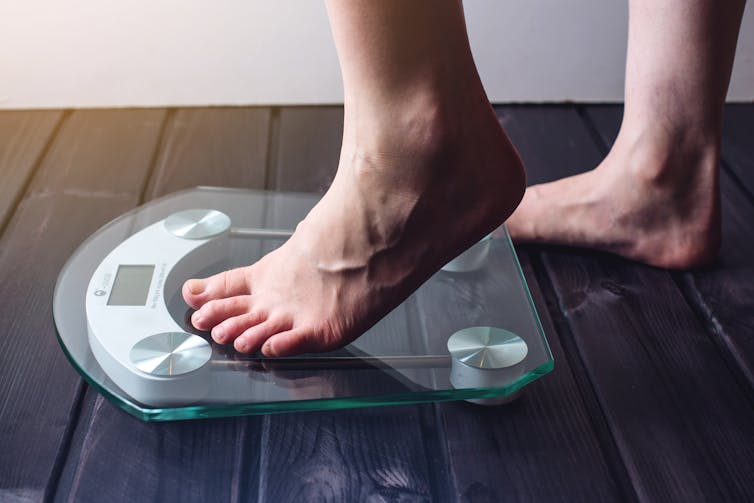 Person steps onto scales