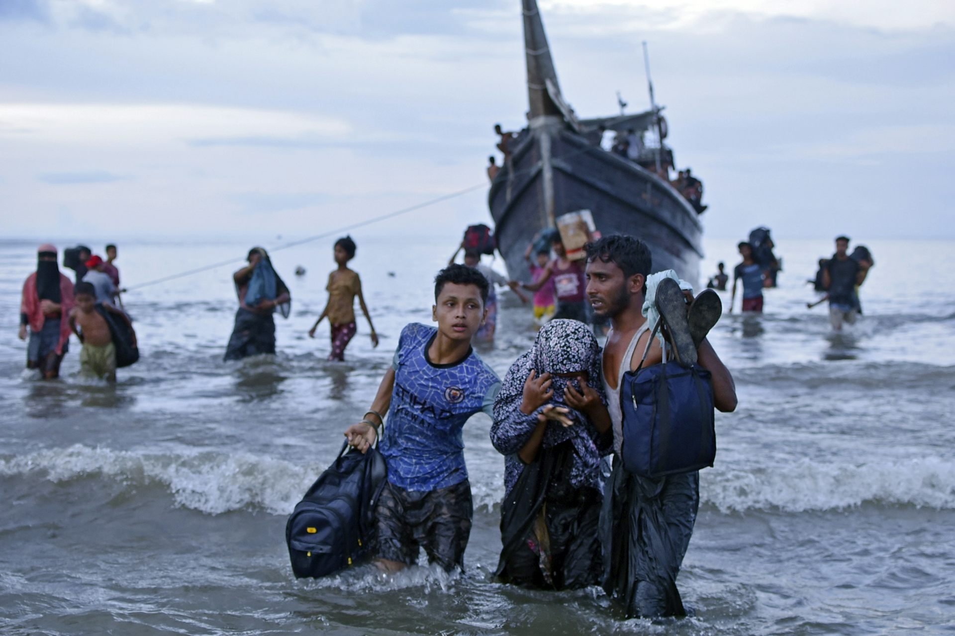 Rohingya refugees disembark from a boat in Indonesia.