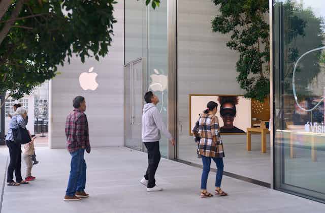 Customers walk into an Apple store in the US