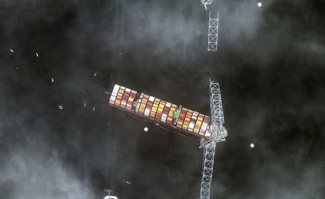 Satellite photo showing a container ship entangled with the wreckage of a bridge.