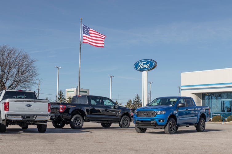 three large utes under US flag and Ford sign
