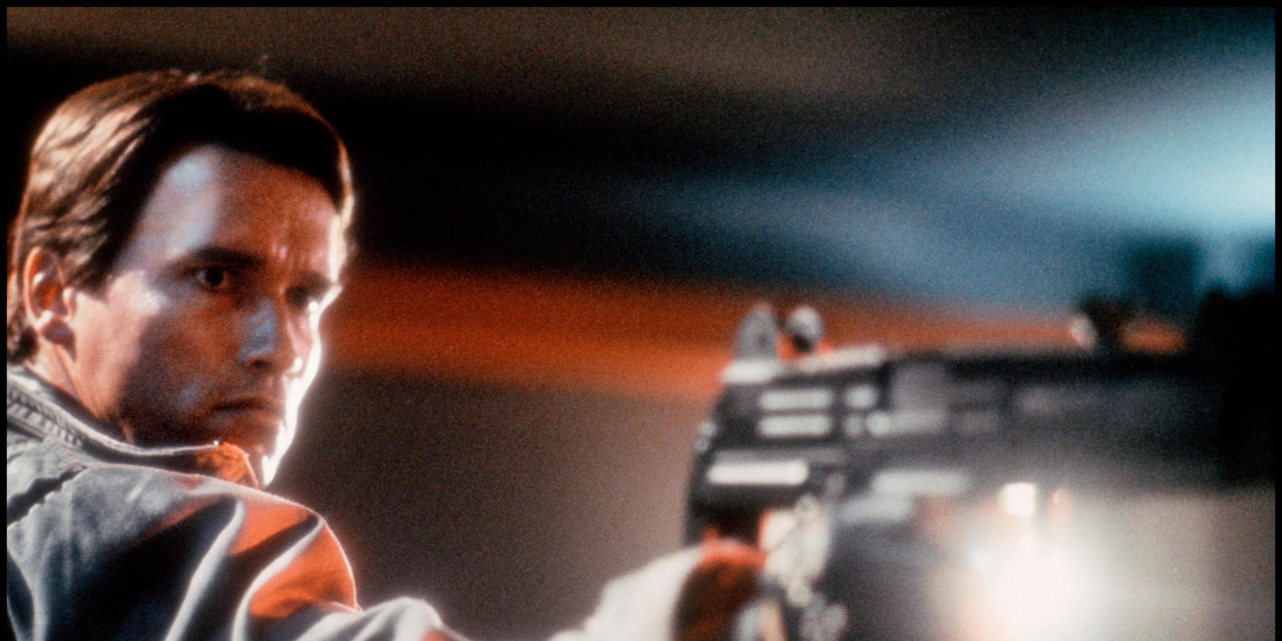 Arnold Schwarzenegger in The Terminator holding a gun