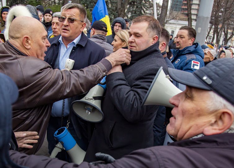 Protesters fight during a demonstration by Moldovan opposition party Shor.